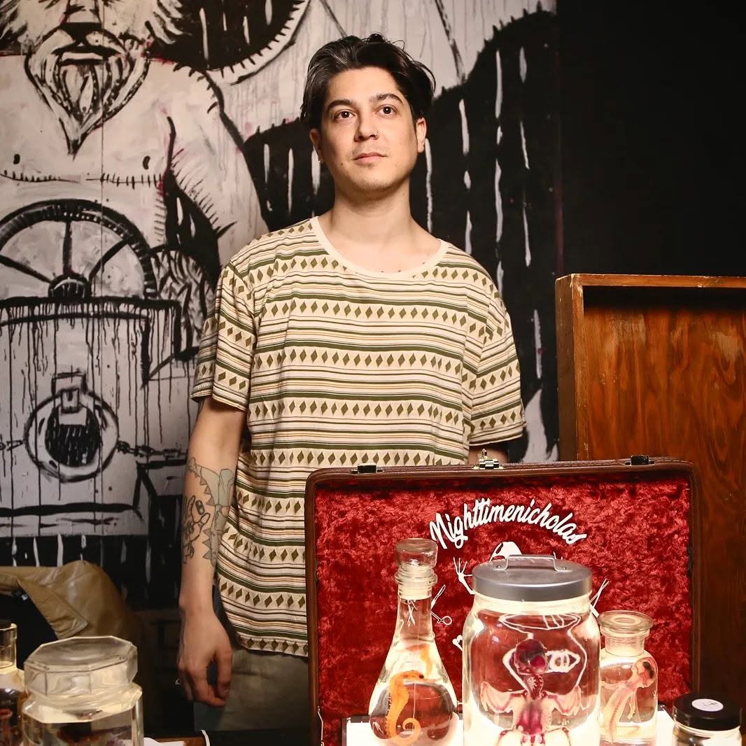 Vendor with wet specimen collection, courtesy of Nighttimenicholas